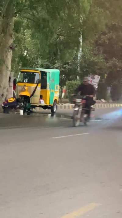 This guy blocked the Fast Lane of the busy road Canal Road in Faisalabad. Just to wash his Rikshaw.