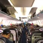 Passengers on Canadian airline calmly wait for their turn to exit the plane