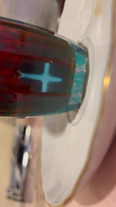 My dad poured tea in this old blue-ish glass and this appeared ??