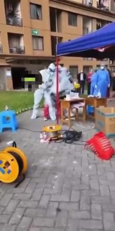 Public health officials in China Forcing a woman to take an anal swab