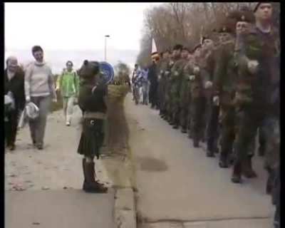 A lone young Belgian boy saluting the Canadians after waiting more than a minute (in source). He is rewarded with an 