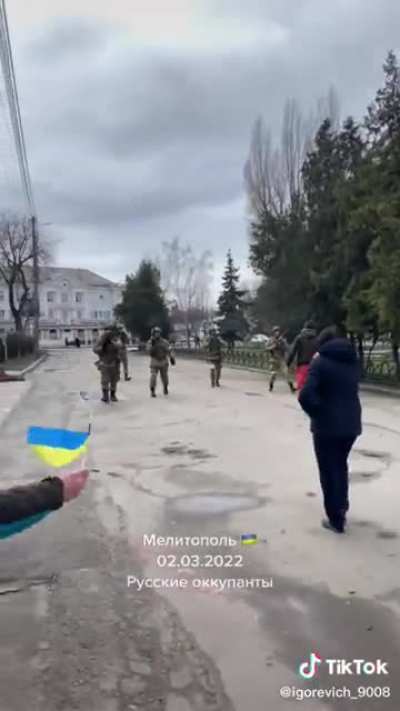 Ukrainian civilians standing up against russian forces as they fire multiple warning shots. (Found on Itemfix)