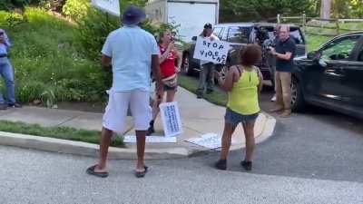 Woman protests Bill Cosby outside his home yesterday. A couple Bill Cosby supporters argue with her