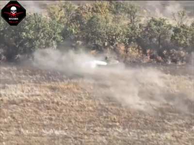 FPV drone hits Russian BMP-2 as cluster munitions detonate around it. Northwest of the village of Vodiane, Donetsk Oblast. Drone operators from the Bulava unit, 72nd Mechanized Brigade, October 11, 2024
