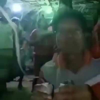 Video of man plugging and unplugging lights to keep the party going. Maybe Southeast Asian? Very fun song