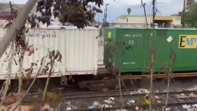 Train becoming derailed after driving through trash/debris