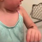 Toddlers reaction after her mom tells her the chocolate pudding on her arm is poop.