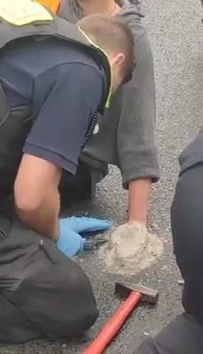 Protester attached his hand with instand beton to block the street