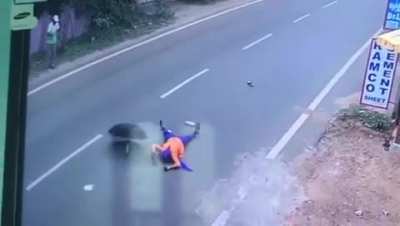 Woman opens up an umbrella while traveling on the back of a motorcycle