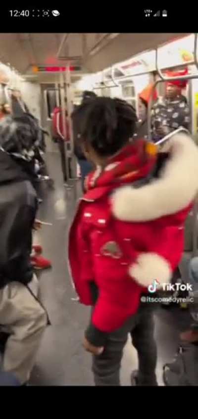 Guy in a Santa-merch elbow dropping a sleeping guy.