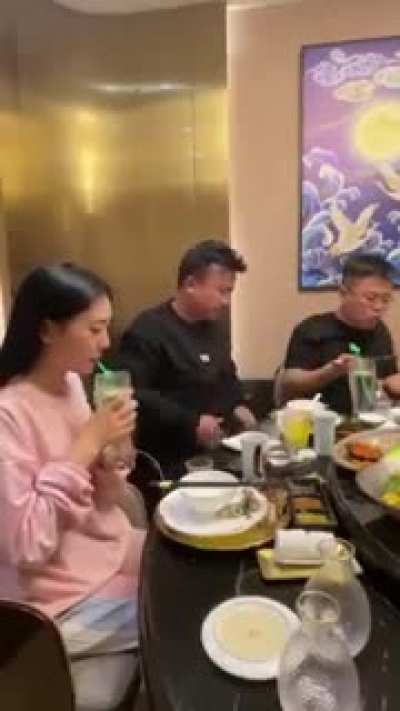 The girl almost chokes on her drink