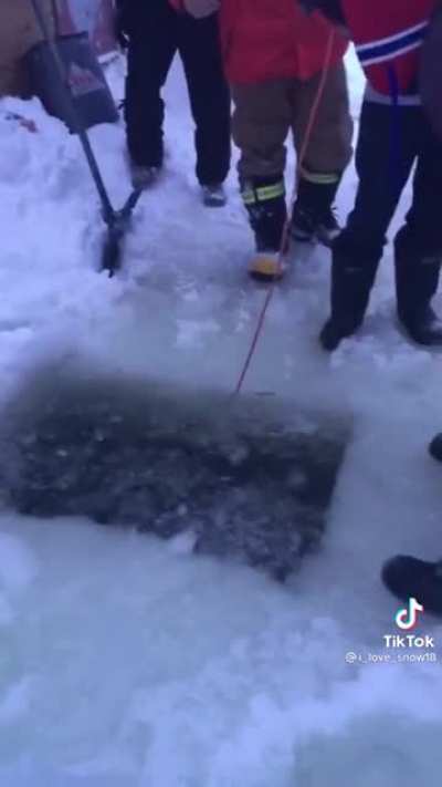 Canadian lost his phone in a frozen lake, so he goes looking for it.