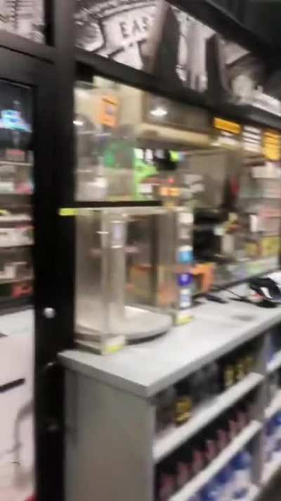 Naked Dude curled up in the fetal position in the middle of the store eating flamin hot funyuns