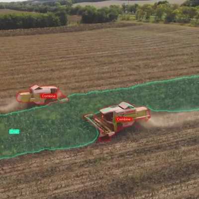 Combines munching through crops as seen by a drone’s machine vision