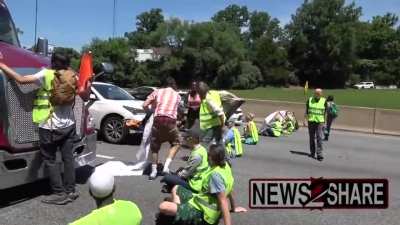 Climate change protesters in Maryland shut down a highway and demand Joe Biden declare a 