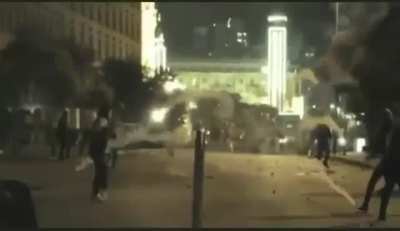 Lebanese potestor kicks back tear gas at police mid air.