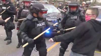 Trying to attack a cop with a large block of concrete
