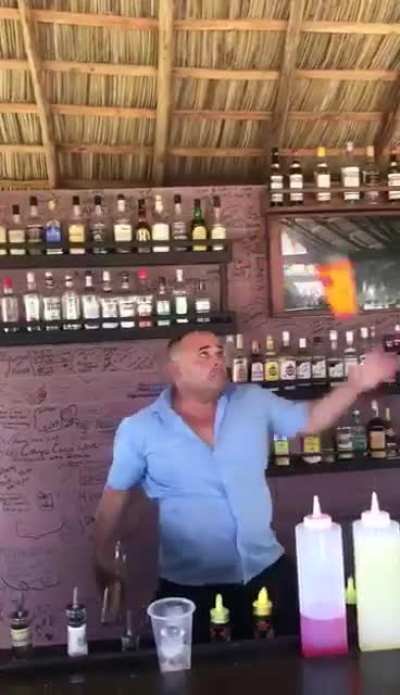 This bartender juggling with bottles