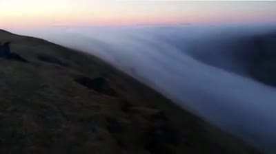 An ethereal waterfall created by a river of fog flowing over the cliffs of Látrabjarg, Iceland, a stunning example of katabatic wind; the downslope flow of cold, dense air under the force of gravity. Credit: Kjartan Gunnsteinsson