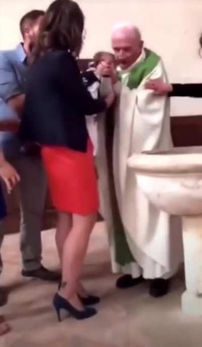 Smacking a frightened infant so you can continue to dip him him the holy tap water in peace