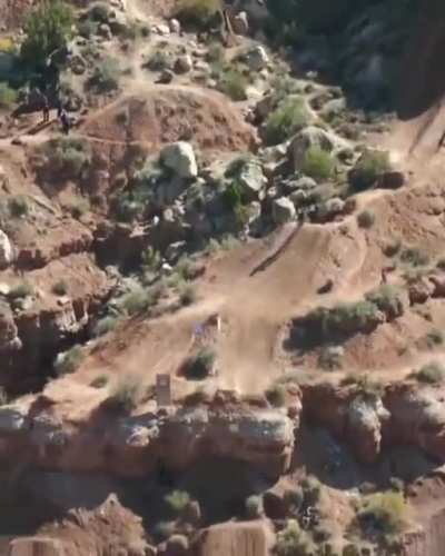 This mountain biker going down a mountain.