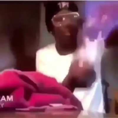 Man covers hand in wax and sets it on fire