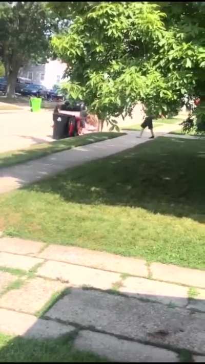 White people ambush black man walking down the street.