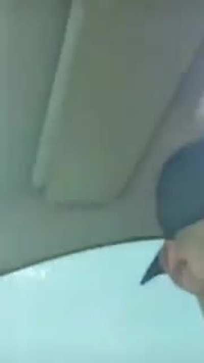 Geniuses lighting a bottle rocket in a car