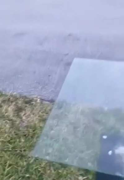 Throwing a concrete slab at a glass desk,