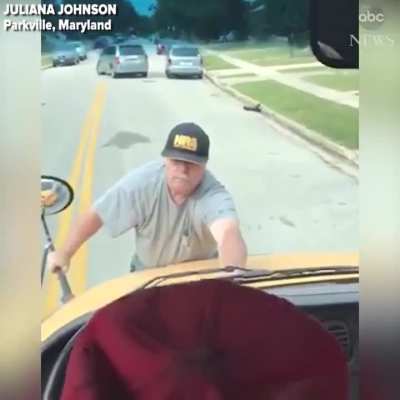 Guy jumps on hood of a school bus after a student threw a water bottle that hit his car