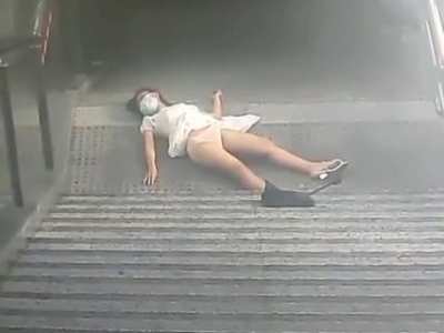 A poor Chinese girl falls from the stair because she keeps looking at her phone, and no one is helping her