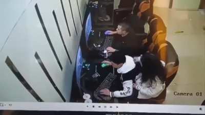 A surveillance camera from inside a video game store in China captured the moment a man assaulted his girlfriend after she repeatedly touched his shoulder making him lose his focus on the game.