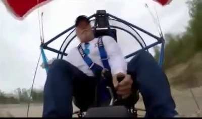 Man hits a tree while using a parachute aircraft.