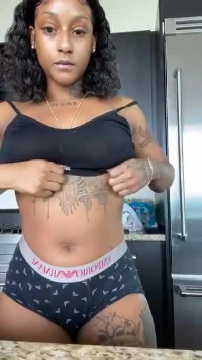 Showing her tattoos