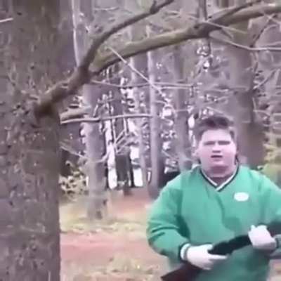 Kid tries to climb a tree with a shotgun