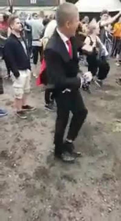 Dude in a suit looks out of place at festival