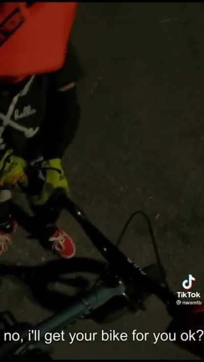 Little dude falls while riding. A good man stops and helps him out.