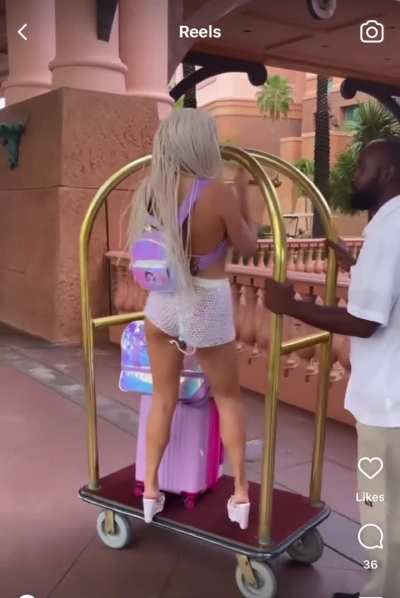 The workers look so annoyed. The one guy even shakes his head “no” when she’s on the luggage cart