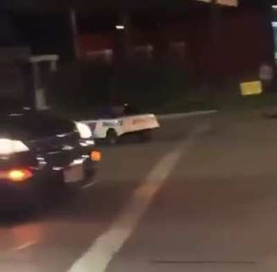 Recording the aftermath of an accident at an intersection.