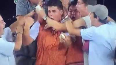 Cricket fans celebrate their friend's nice catch