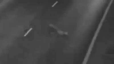 This 2007 footage taken in England shows a humanoid creature crossing a road at a high rate of speed