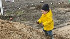 My toddler climbing a pile of sand, victory is short lived.