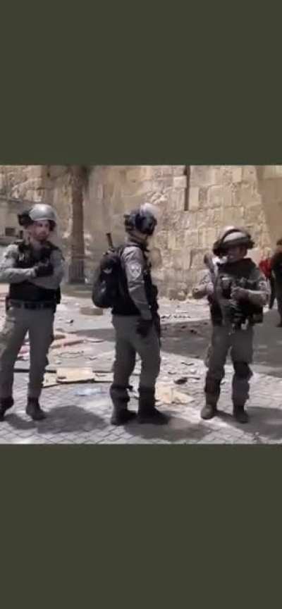 A journalist caught an israeli soldier about to throw a grenade at medics and am ambulance but he stopped when she caught him on camera.