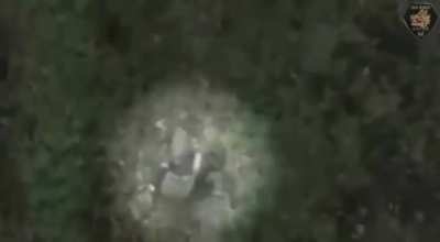 Russian soldier pulls the grenade pin while walking