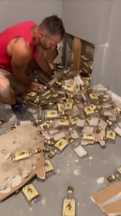 Guy pulls bottles out of a wall in his new house