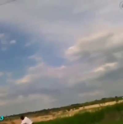 Kid throwing a copper wire-wrapped rock at a power line