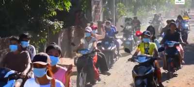 Protestors in Myanmar ride scooters to show their opposition to military rule