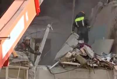 Building collapses onto emergency workers who were clearing debris after an earlier gas explosion on the outskirts of Moscow.