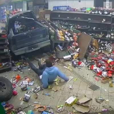 Guy crashes car into Michigan gas station, and then attempts to remove the license plate before fleeing