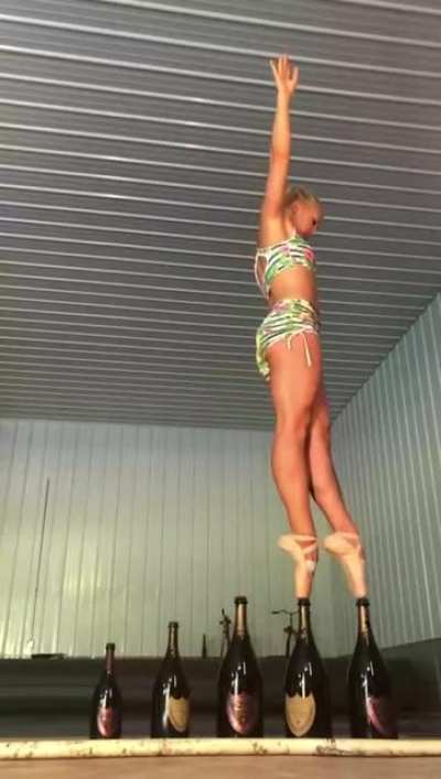Ballerina balancing on bottles